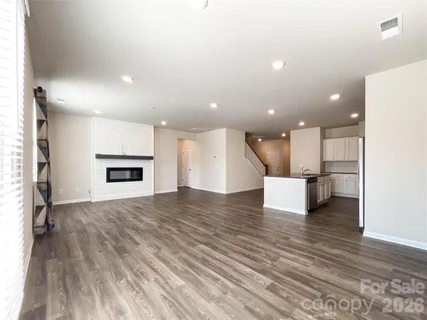 a view of kitchen with kitchen island refrigerator stove microwave and cabinets
