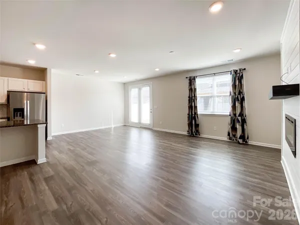 an empty room with large windows