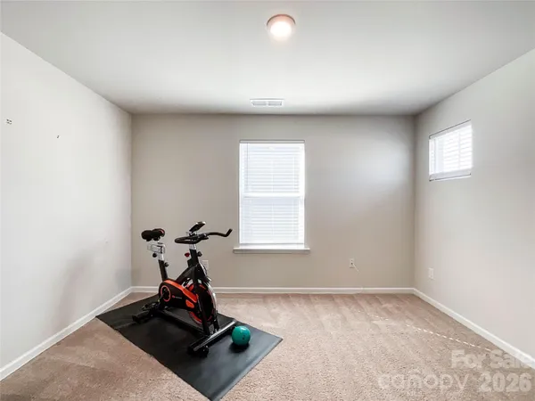 a view of a room with equipment and wooden floor