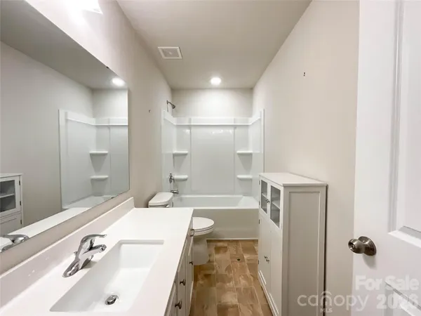 a view of a room with rack on the wall and a window