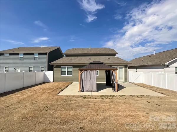 a view of backyard with a patio and a yard