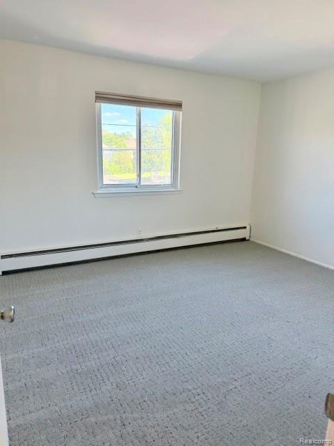 805 Plate Street, Unit 210 Rochester, MI 48307 - Photo 15 of 20 Carpeted empty room featuring a baseboard radiator and baseboards