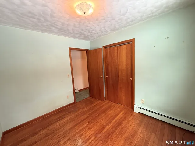 a view of a room with wooden floor