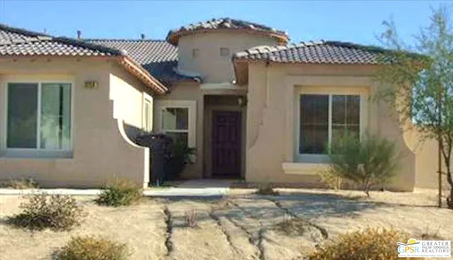 a view of a house with potted plants