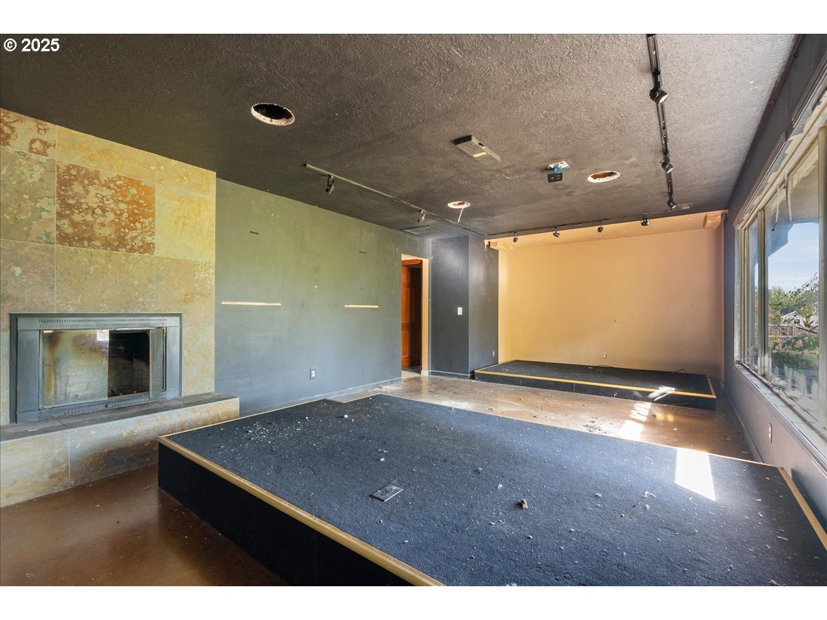 2617 Northeast 166th Street Ridgefield, WA 98642 - Photo 15 of 35 a view of an empty room with a fireplace and a flat screen tv