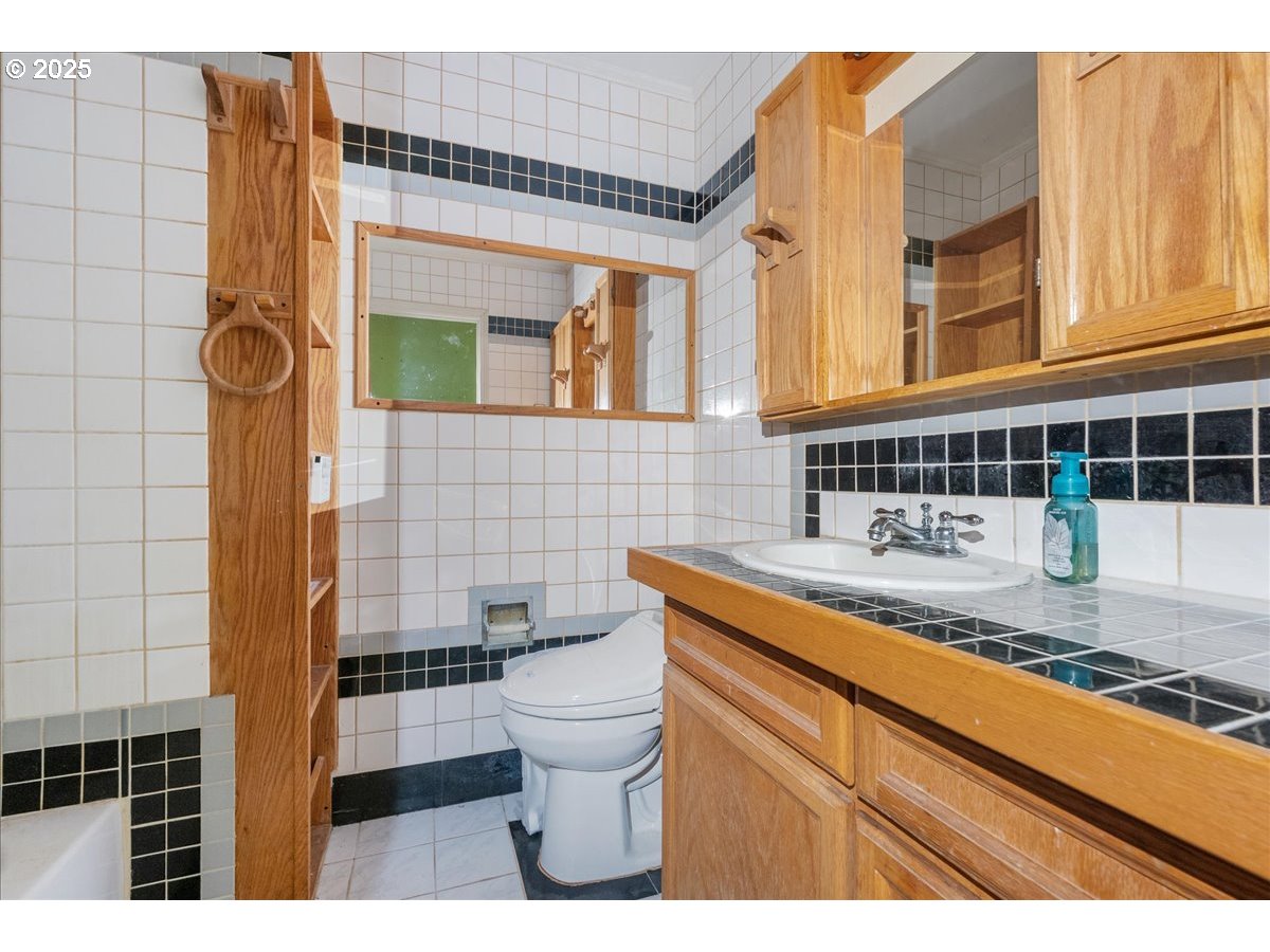 2617 Northeast 166th Street Ridgefield, WA 98642 - Photo 18 of 35 a bathroom with a sink a toilet and shower