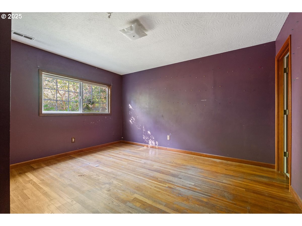 2617 Northeast 166th Street Ridgefield, WA 98642 - Photo 19 of 35 a view of an empty room with wooden floor and a window