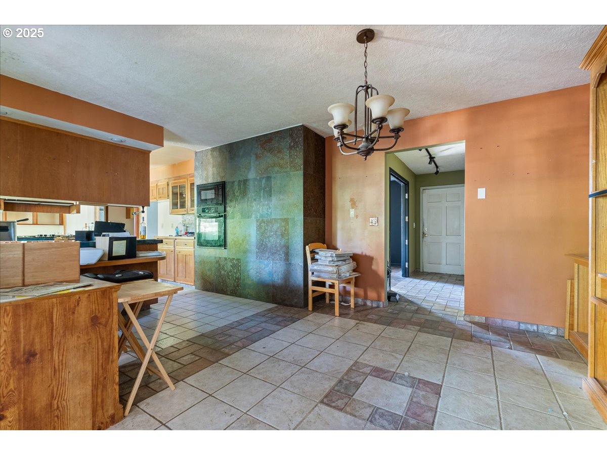 2617 Northeast 166th Street Ridgefield, WA 98642 - Photo 24 of 35 a view of a dining room with furniture and a chandelier