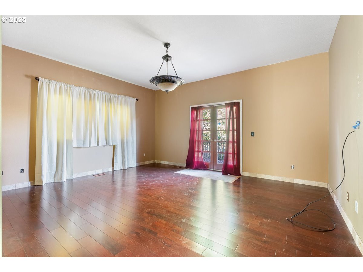 2617 Northeast 166th Street Ridgefield, WA 98642 - Photo 31 of 35 a view of an empty room with wooden floor and a window