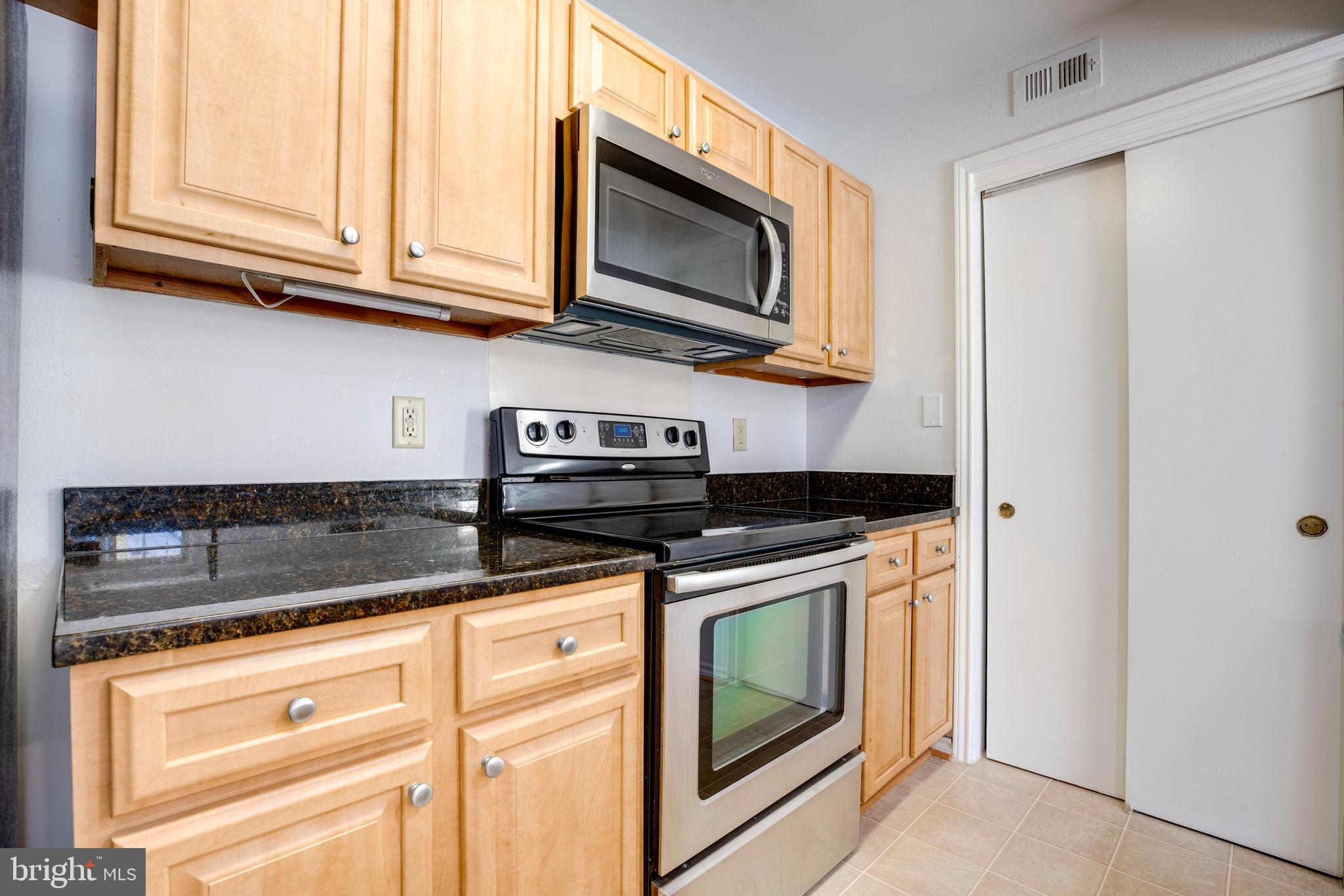 12154 Penderview Terrace, Unit 1231 Fairfax, VA 22033 - Photo 11 of 25 a stove top oven sitting inside of a kitchen