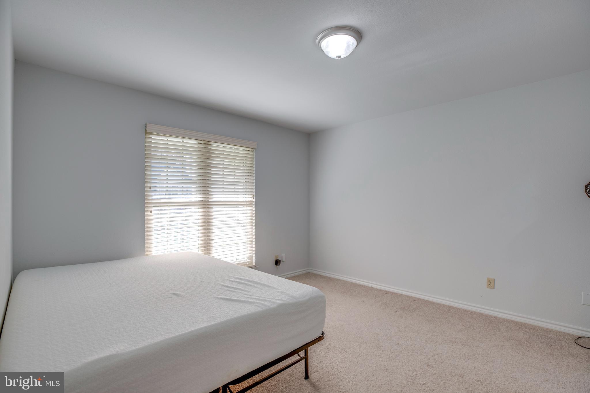 12154 Penderview Terrace, Unit 1231 Fairfax, VA 22033 - Photo 14 of 25 a room with a bed and a window