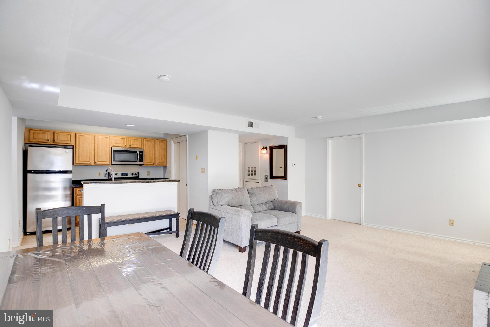 12154 Penderview Terrace, Unit 1231 Fairfax, VA 22033 - Photo 6 of 25 a view of a living room hardwood floor and a kitchen