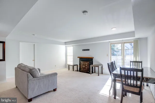 a living room with furniture and a dining table with fireplace