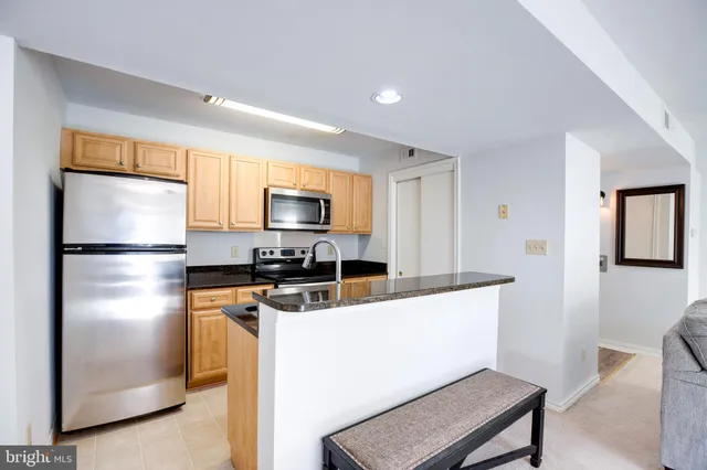 a kitchen with stainless steel appliances a refrigerator stove microwave and sink