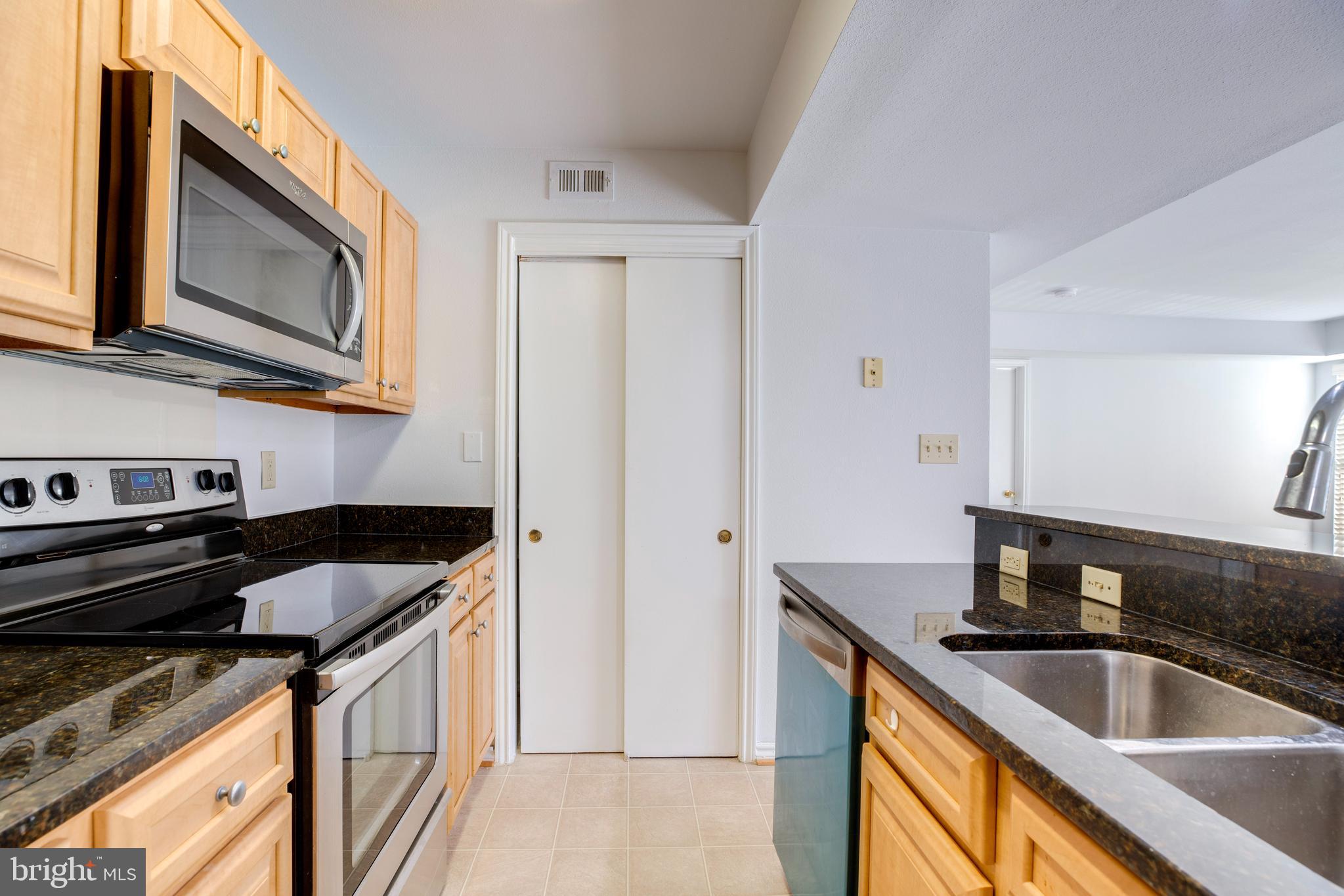 12154 Penderview Terrace, Unit 1231 Fairfax, VA 22033 - Photo 10 of 25 a kitchen that has a sink and a stove