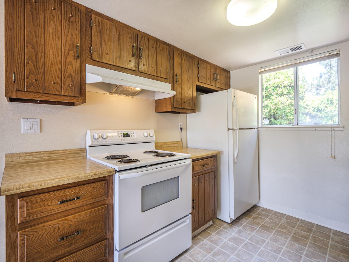 450 Spruce Circle Watsonville, CA 95076 - Photo 22 of 30 a kitchen with a stove cabinets and a refrigerator