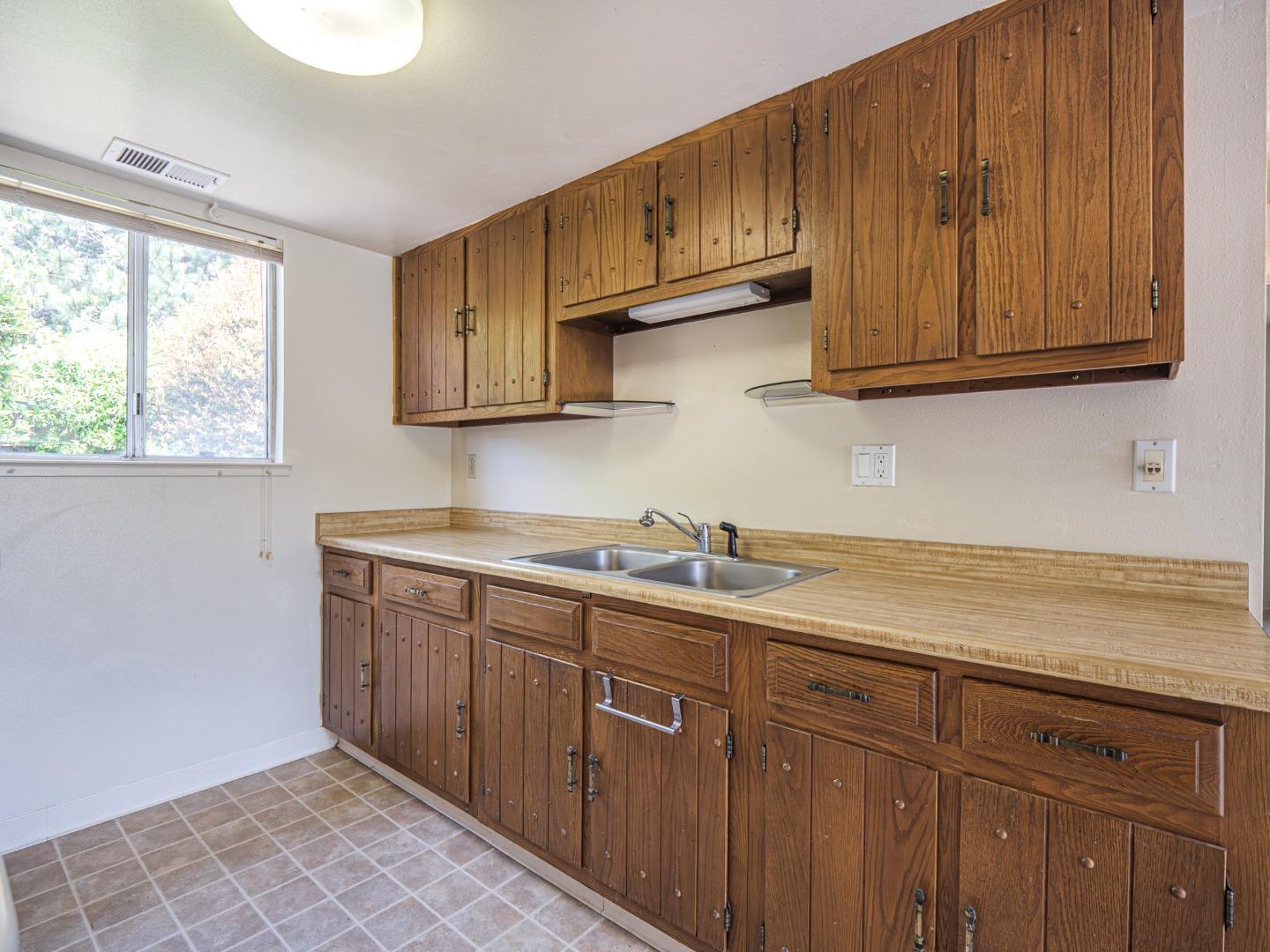 450 Spruce Circle Watsonville, CA 95076 - Photo 23 of 30 a kitchen with stainless steel appliances granite countertop a sink window and cabinets