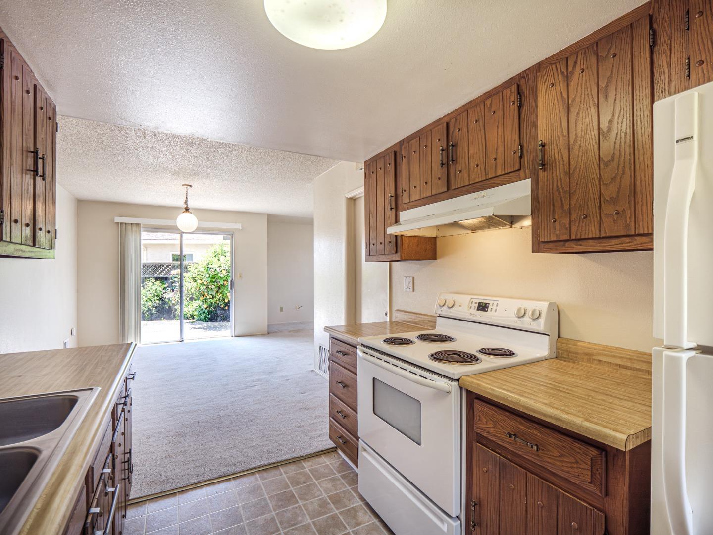 450 Spruce Circle Watsonville, CA 95076 - Photo 24 of 30 a kitchen with granite countertop a stove and a sink