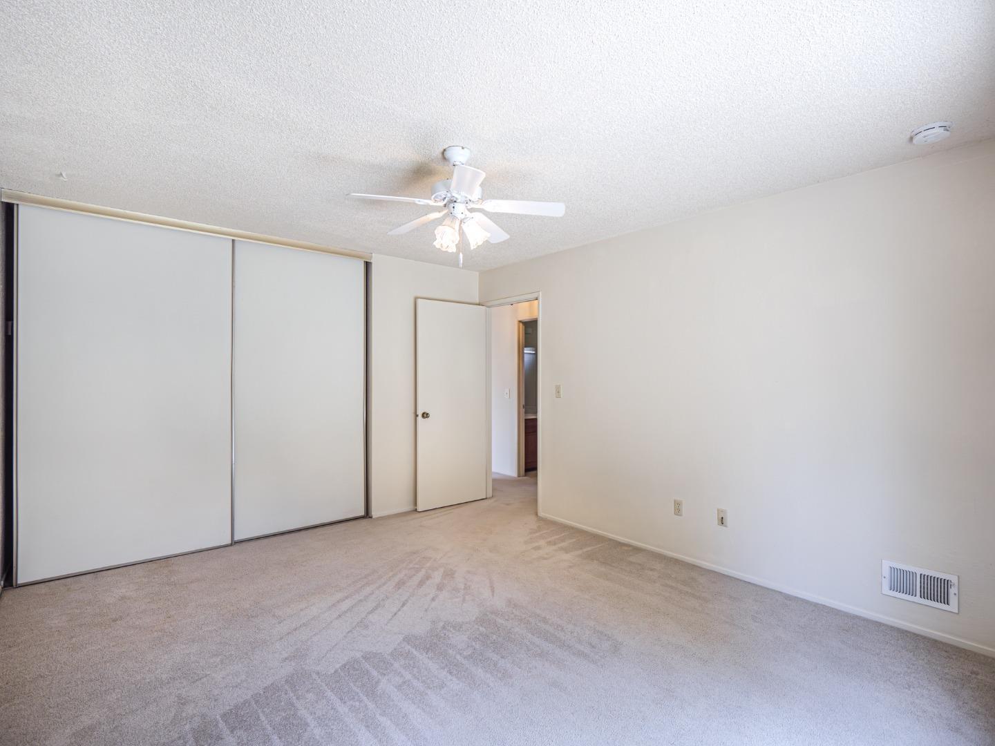 450 Spruce Circle Watsonville, CA 95076 - Photo 26 of 30 an empty room with a ceiling fan and a window