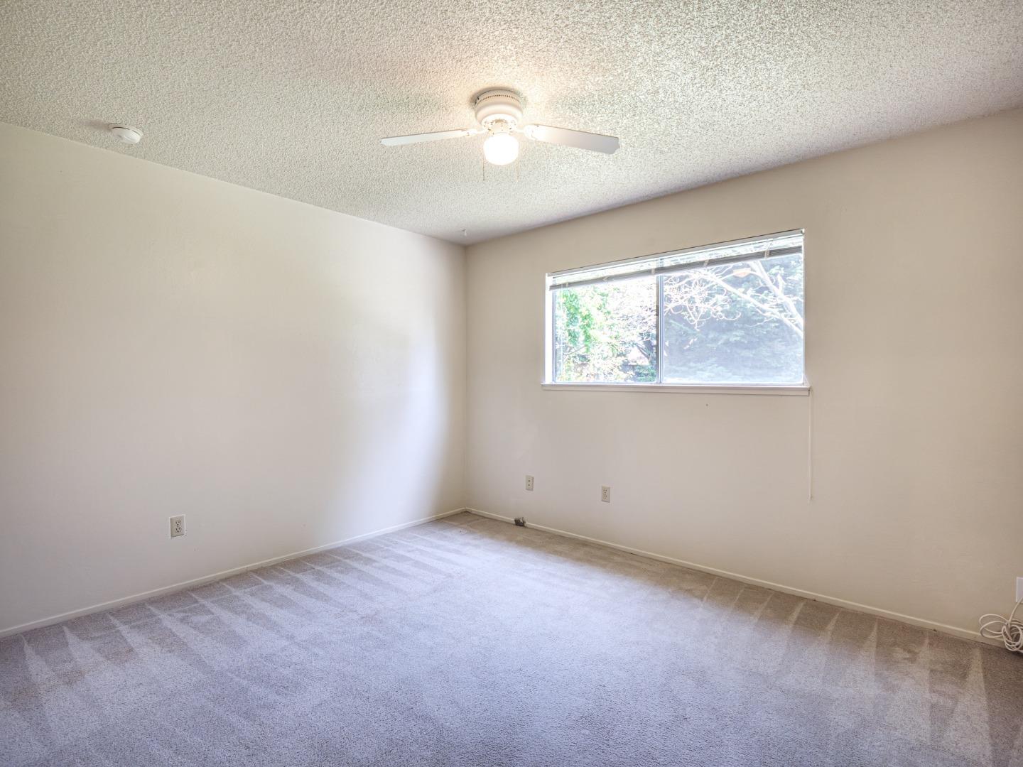 450 Spruce Circle Watsonville, CA 95076 - Photo 27 of 30 an empty room with windows and fan