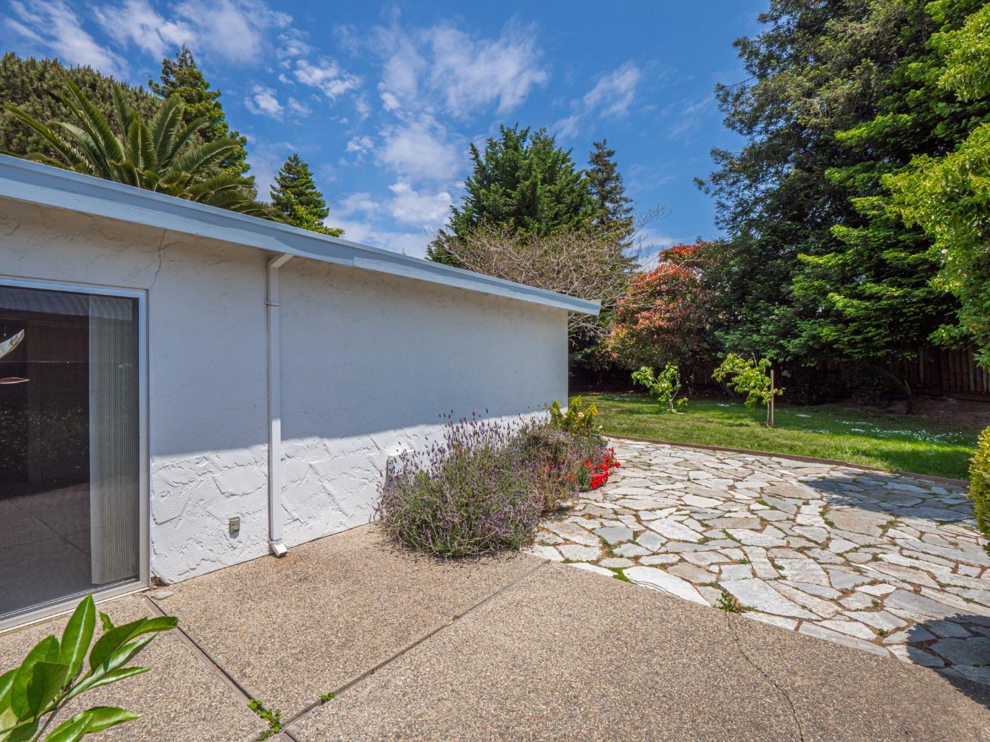 450 Spruce Circle Watsonville, CA 95076 - Photo 5 of 30 a wooden bench sitting in front of a house