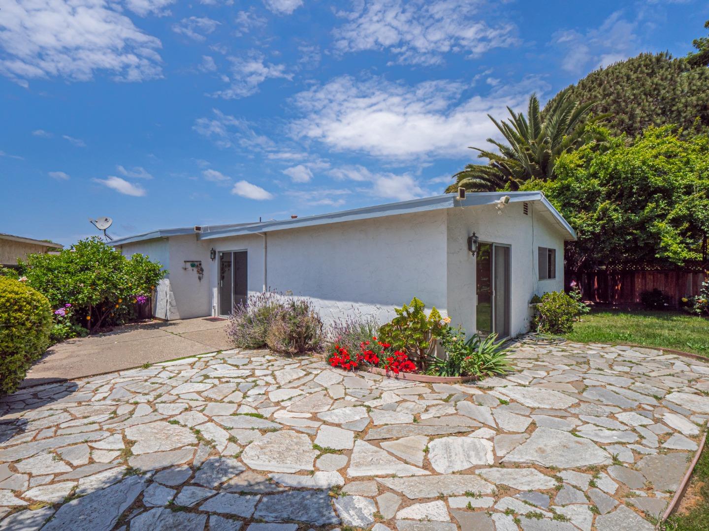 450 Spruce Circle Watsonville, CA 95076 - Photo 6 of 30 a front view of a house with a yard and a garden