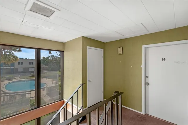 a view of a hallway with wooden floor and staircase