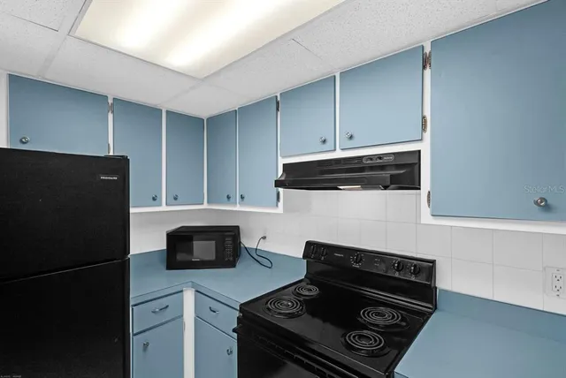 a kitchen with a stove and a refrigerator