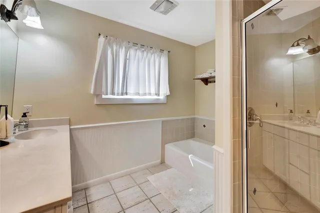 a bathroom with a double vanity sink and a mirror