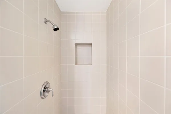 a view of a patio with a table chairs and a floor to ceiling window