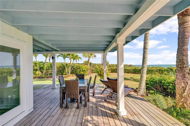 a view of a sitting area with swimming pool and green space