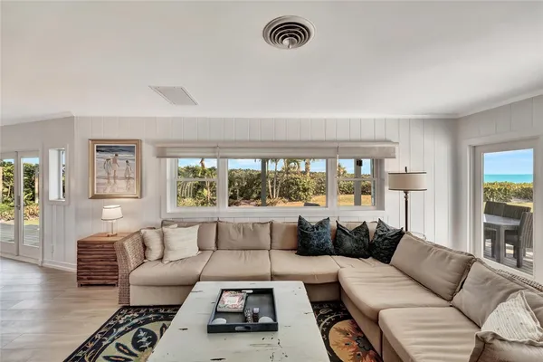 a living room with furniture fireplace and a large window