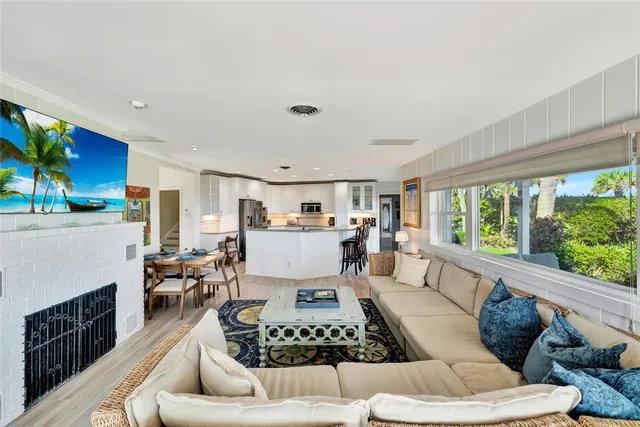 a large kitchen with granite countertop a large counter top appliances and cabinets