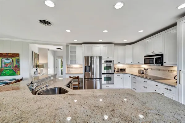 a kitchen with sink stove and cabinets