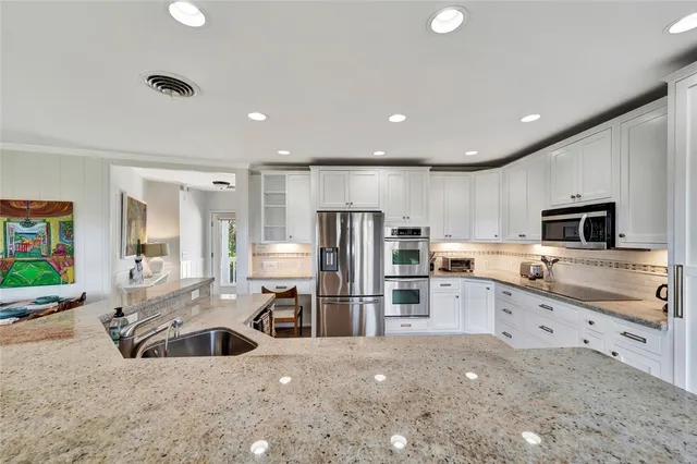 a kitchen with sink stove and cabinets