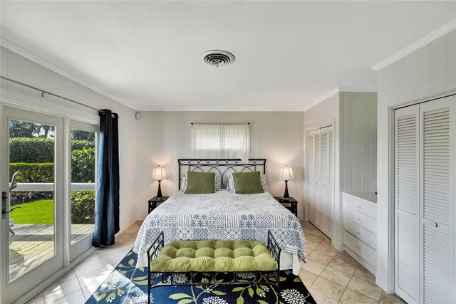 a bedroom with a bed and a large window