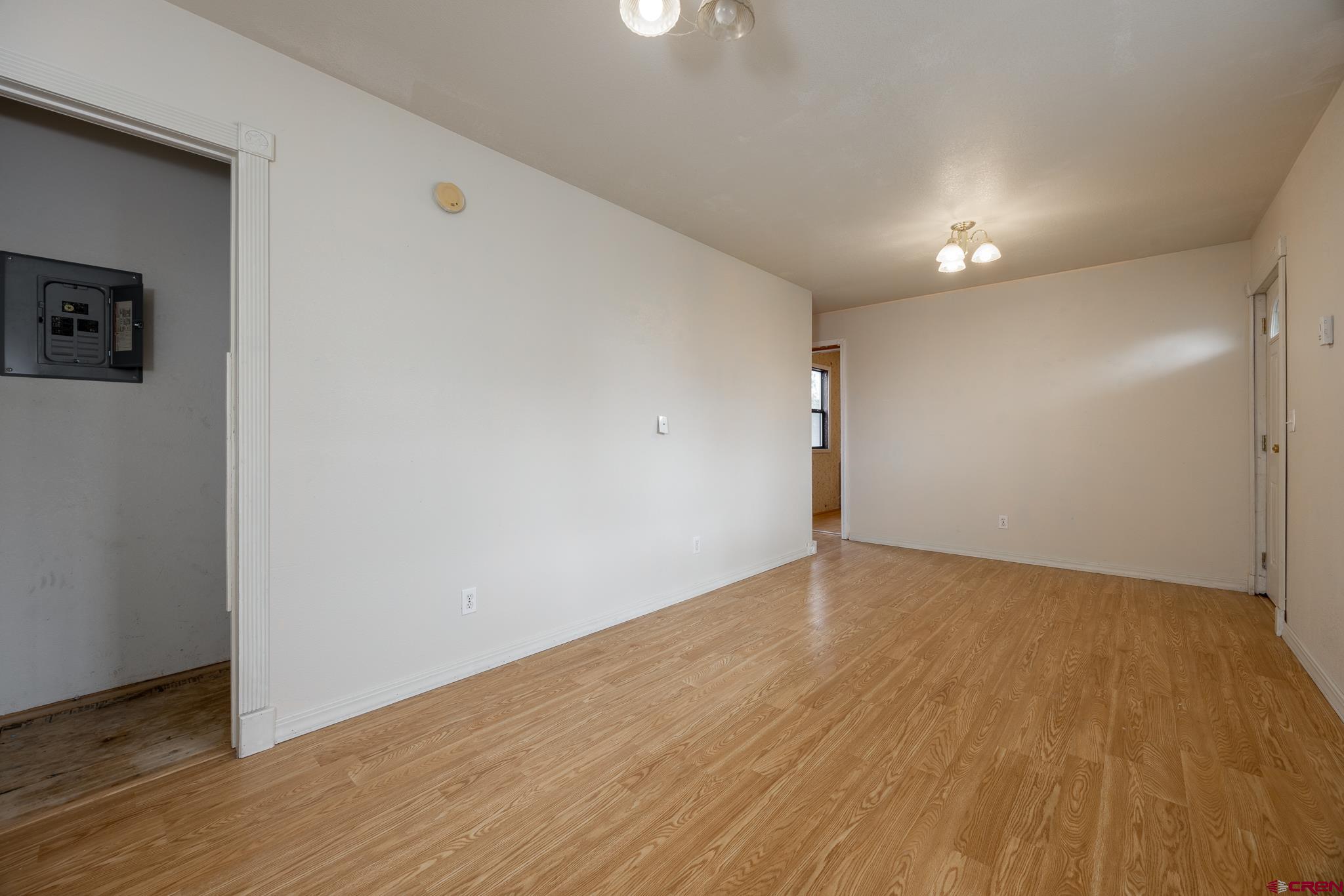 537 North Elm Street Cortez, CO 81321 - Photo 35 of 41 an empty room with wooden floor and windows