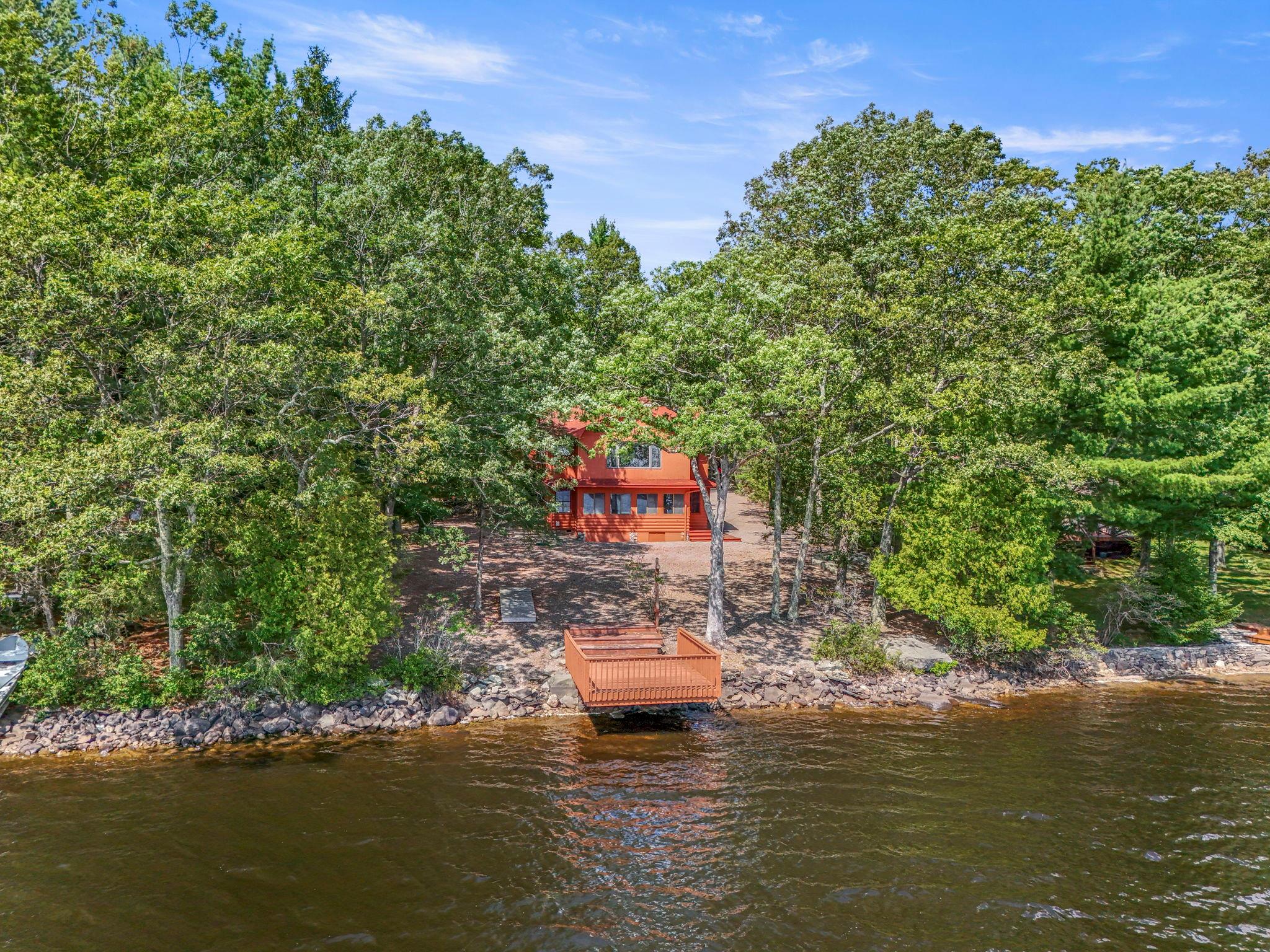 a swimming pool with trees in the background