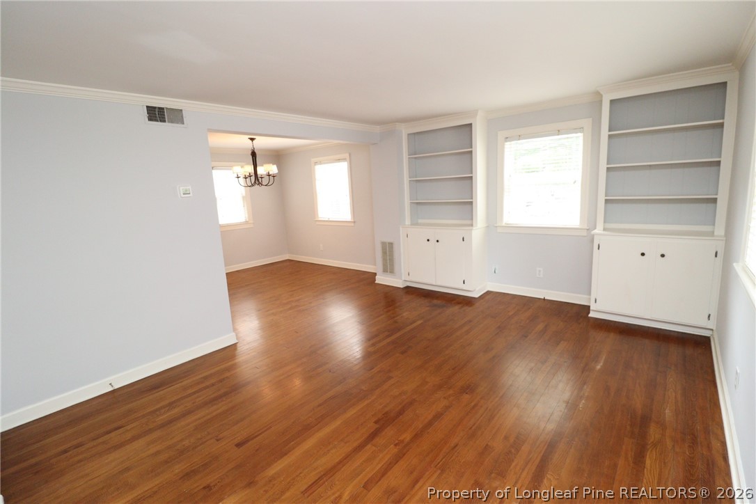 1000 Nichols Drive Raleigh, NC 27605 - Photo 2 of 22 wooden floor in an empty room with a window
