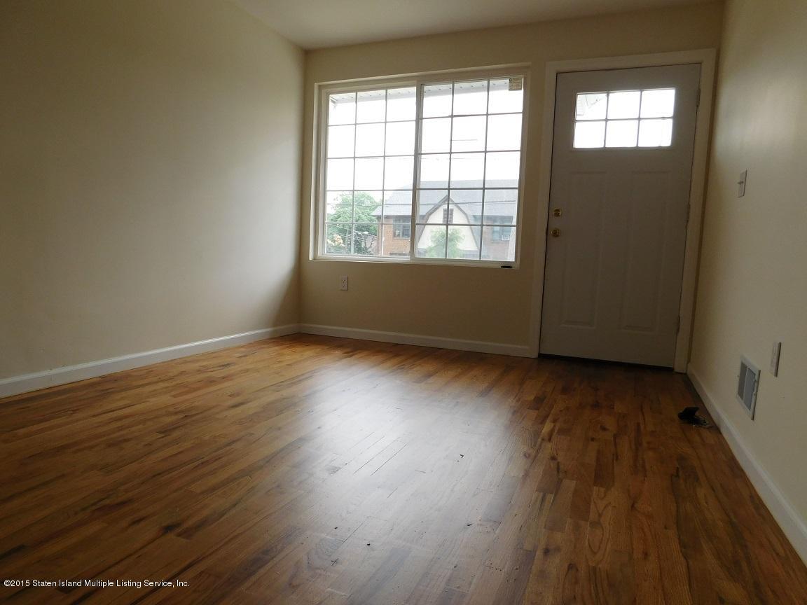 104 Willowbrook Road Staten Island, NY 10302 - Photo 12 of 16 an empty room with wooden floor and windows