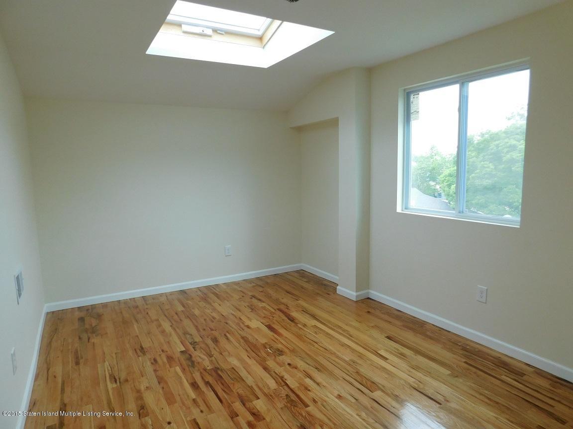 104 Willowbrook Road Staten Island, NY 10302 - Photo 16 of 16 an empty room with wooden floor and windows