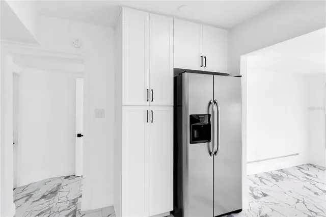 a view of a livingroom with a window and a ceiling fan