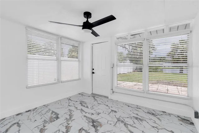 a view of a big room with wooden floor and a window