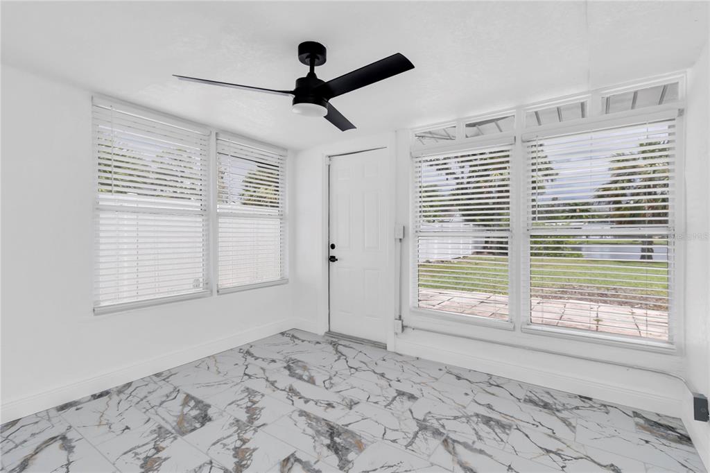 7320 Oelsner Street New Port Richey, FL 34652 - Photo 13 of 29 a view of a livingroom with a window and a ceiling fan