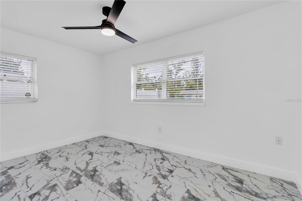 7320 Oelsner Street New Port Richey, FL 34652 - Photo 15 of 29 a view of a big room with wooden floor and a window