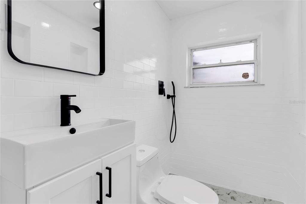 7320 Oelsner Street New Port Richey, FL 34652 - Photo 17 of 29 a bathroom with a toilet sink and mirror