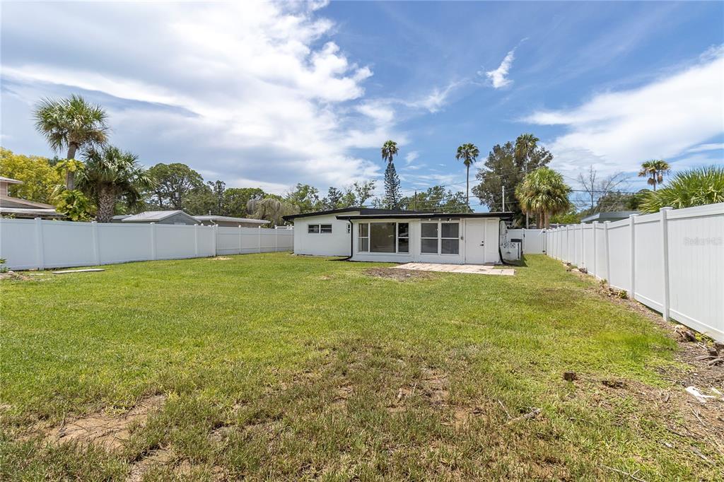 7320 Oelsner Street New Port Richey, FL 34652 - Photo 25 of 29 a swimming pool with trees in the background