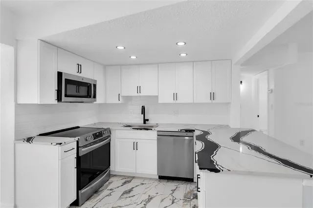 a kitchen with a sink and cabinets