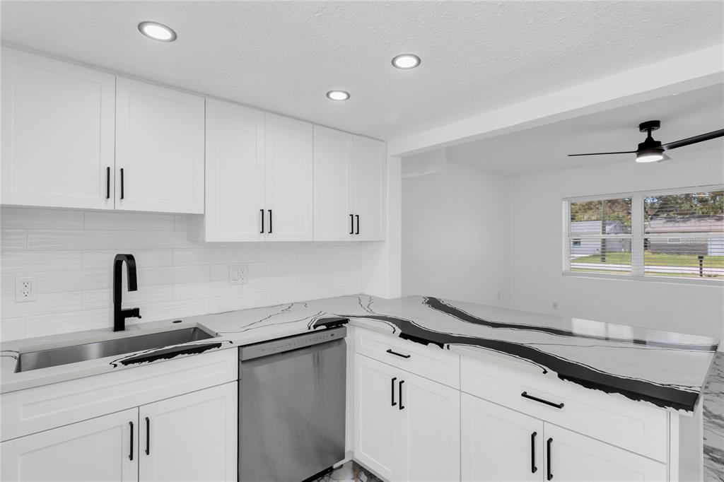 7320 Oelsner Street New Port Richey, FL 34652 - Photo 10 of 29 a kitchen with a sink and cabinets