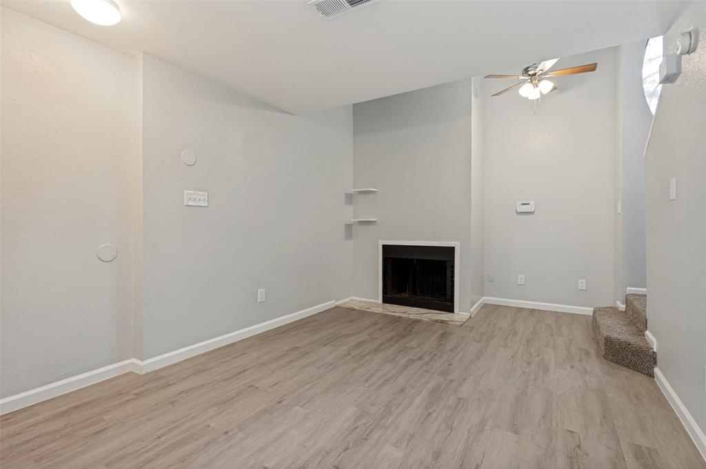 622 West Union Bower Road Irving, TX 75061 - Photo 8 of 13 Living area featuring wood-finish flooring, a fireplace with a dark surround, and built-in shelving